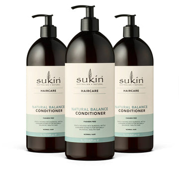 Three bottles of Sukin Natural Balance Conditioner on a white background