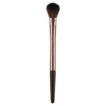 Makeup brush with rose gold handle and black bristles on a white background