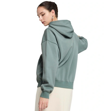 Person wearing a green hoodie on a white background