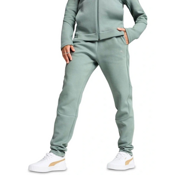Person wearing a light green tracksuit with white sneakers on a white background