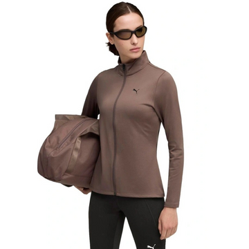Woman wearing a brown athletic jacket and black leggings with a duffel bag on a white background