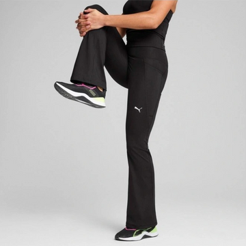 Person wearing black athletic pants with a visible brand logo on a gray background