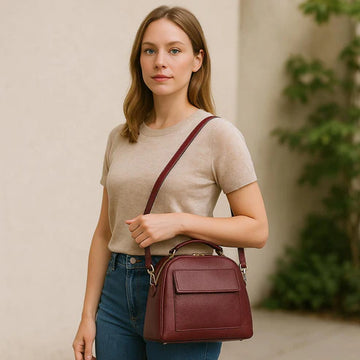 Elegant dark red genuine leather women’s satchel handbag with structured medium design and gold-tone accents — perfect for everyday and office wear.