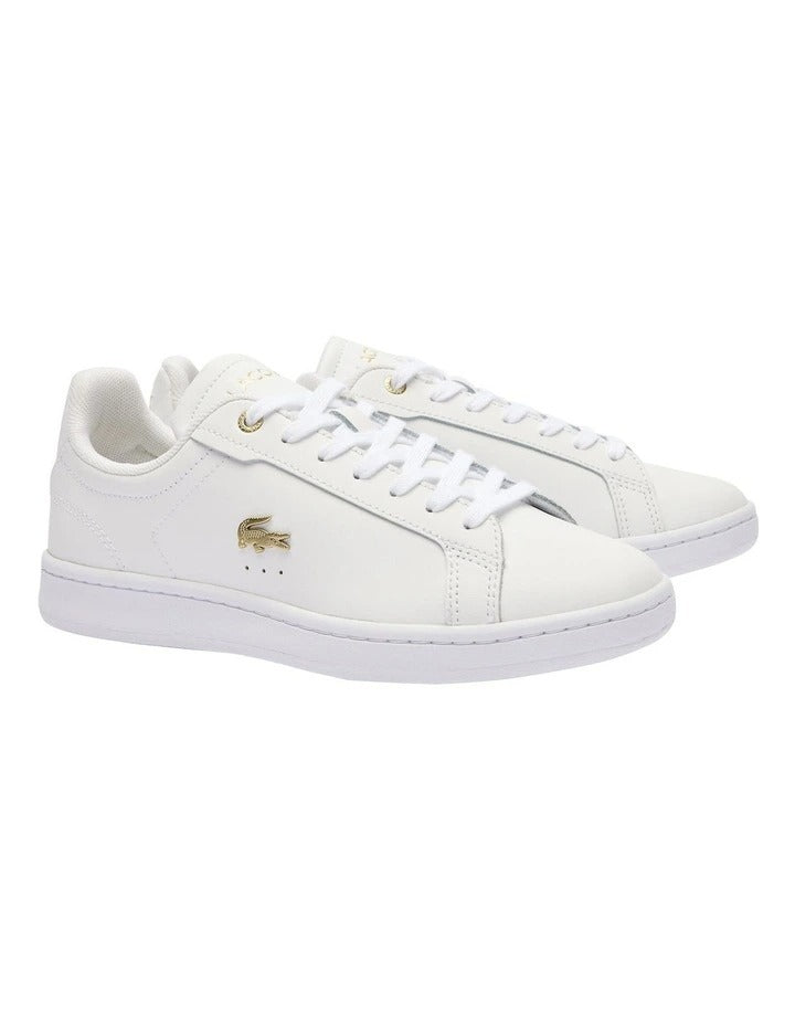 Lacoste Carnaby Pro Leather Sneakers in White/Gold, featuring a sleek leather upper with gold accents for a luxurious, stylish design.