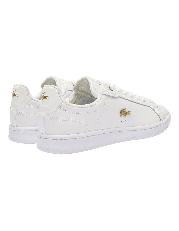 Lacoste Carnaby Pro Leather Sneakers in White/Gold, featuring a sleek leather upper with gold accents for a luxurious, stylish design.