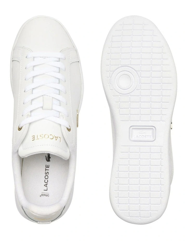 Lacoste Carnaby Pro Leather Sneakers in White/Gold, featuring a sleek leather upper with gold accents for a luxurious, stylish design.