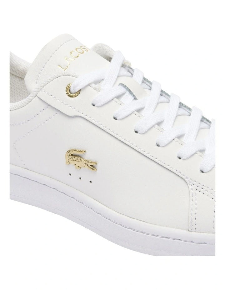 Lacoste Carnaby Pro Leather Sneakers in White/Gold, featuring a sleek leather upper with gold accents for a luxurious, stylish design.