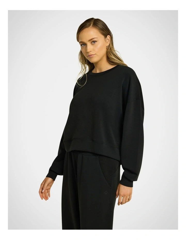 Rockwear Travel Hip Length Crew Jumper in Black, women's cozy crew neck sweater with relaxed fit and ultra-smooth fabric, perfect for travel and everyday wear.