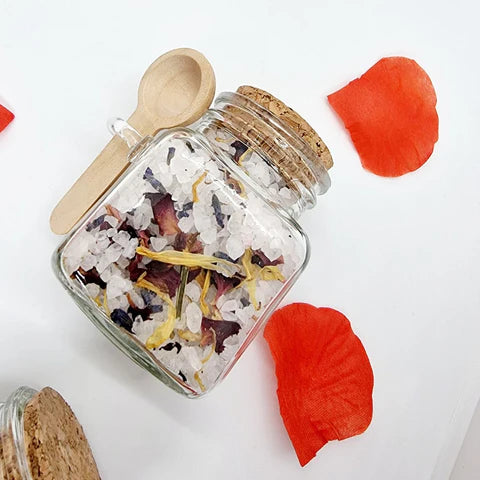 Lavvish Lavender and Rose Bath Salts in glass jar with wooden spoon and floral accents