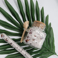 Lavvish Lavender and Rose Bath Salts in glass jar with wooden spoon and floral accents