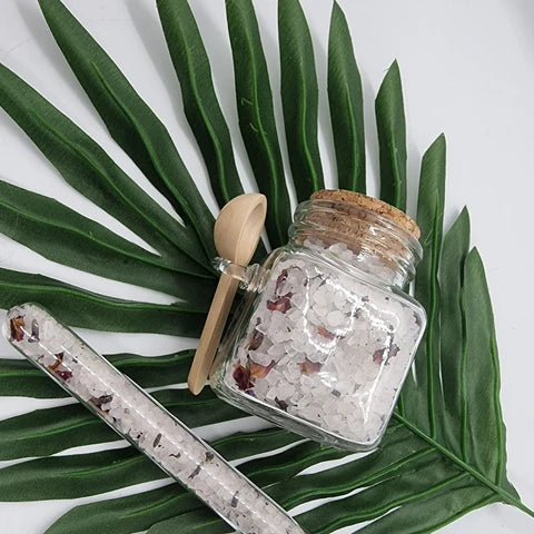 Lavvish Lavender and Rose Bath Salts in glass jar with wooden spoon and floral accents