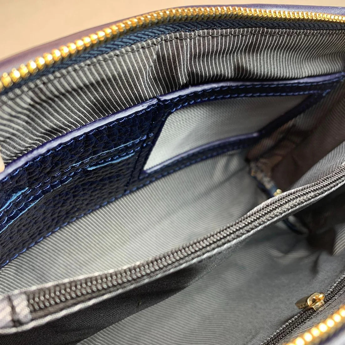 LeatherLuxe dark blue genuine leather clutch and shoulder crossbody bag with sleek design and gold-tone hardware