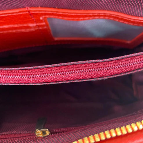 LeatherLuxe premium red leather clutch bag with gold hardware, designed for crossbody and shoulder wear, elegant women's accessory for evening and casual outings.