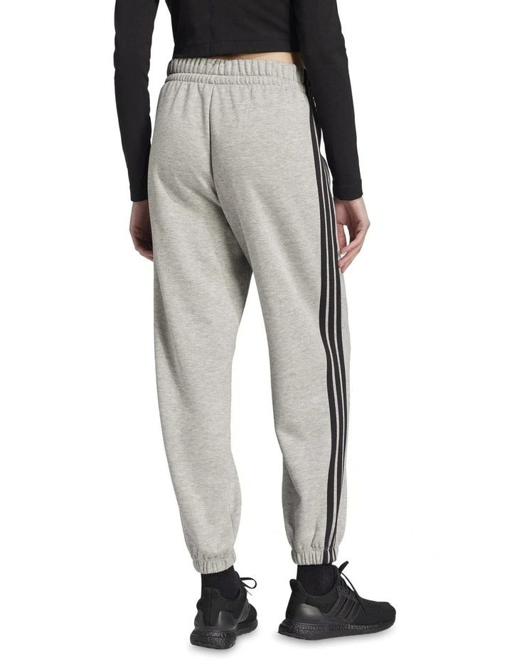 Adidas Essentials 3-Stripes Fleece Loose-Fit Joggers in Grey with soft fleece, loose fit, and iconic 3-Stripes design