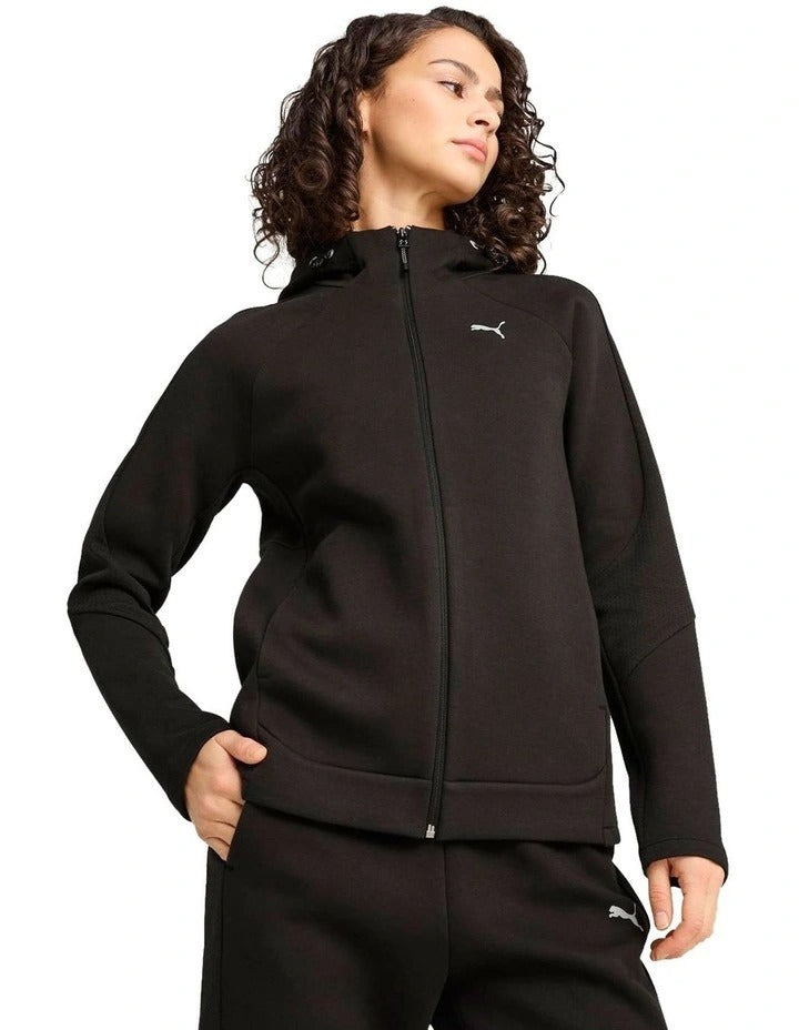 Person wearing a black Puma tracksuit on a white background