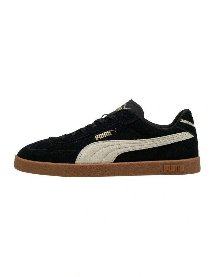 Black and white sneaker with brown sole on a white background