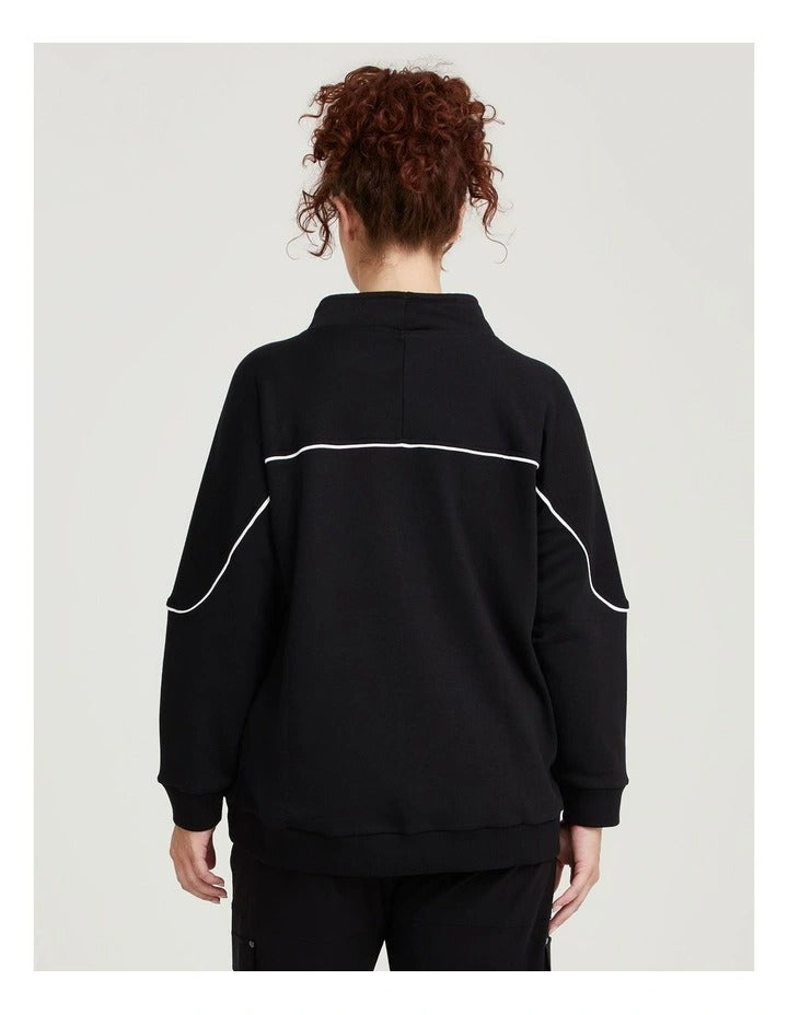 Taking Shape Active Mock Neck Top in Black with cords, ribbed cuffs, thumbholes, and flattering piping detail for plus size comfort and style.