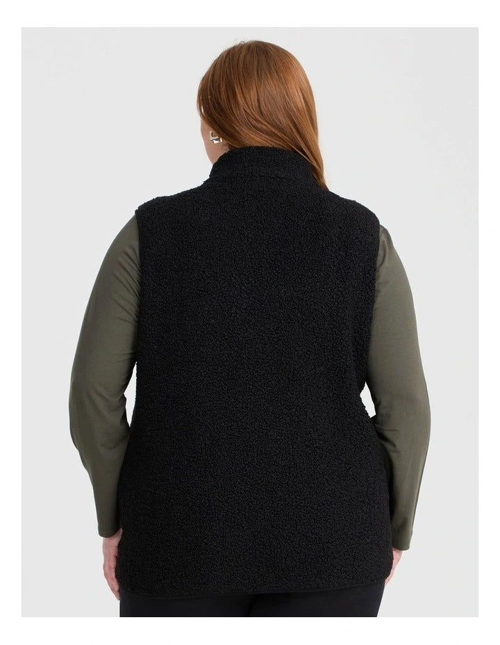 Taking Shape Teddy Vest in Black with plush teddy fabric, zip closure, high neckline, and side pockets for plus size comfort and layering.