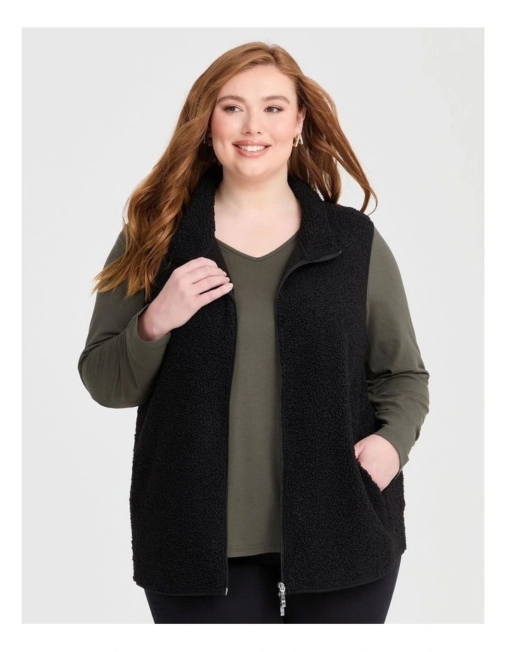 Taking Shape Teddy Vest in Black with plush teddy fabric, zip closure, high neckline, and side pockets for plus size comfort and layering.
