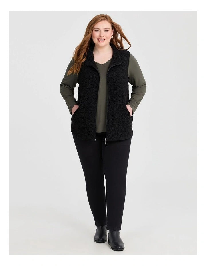 Taking Shape Teddy Vest in Black with plush teddy fabric, zip closure, high neckline, and side pockets for plus size comfort and layering.
