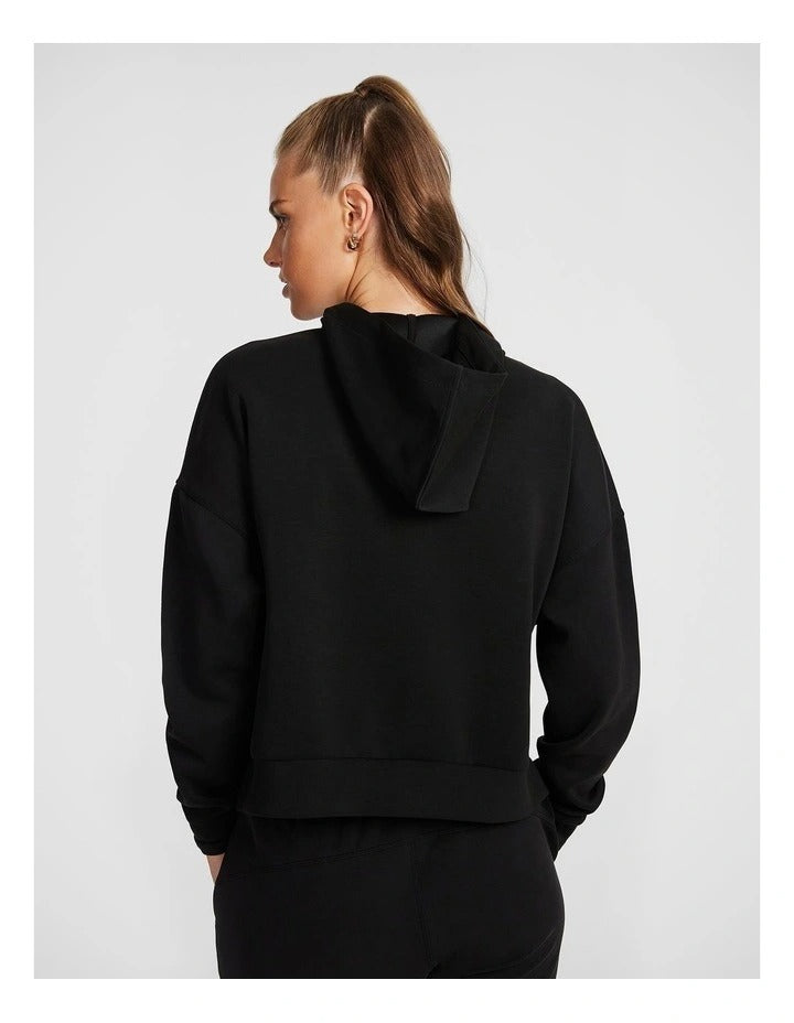 Rockwear Travel Hip Hood Half Zip in Black, featuring a cozy hood and front pockets for a relaxed, stylish look.