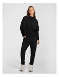 Rockwear Travel Hip Hood Half Zip in Black, featuring a cozy hood and front pockets for a relaxed, stylish look.