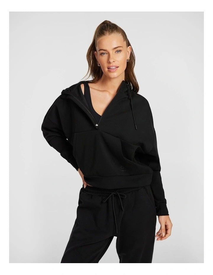 Rockwear Travel Hip Hood Half Zip in Black, featuring a cozy hood and front pockets for a relaxed, stylish look.