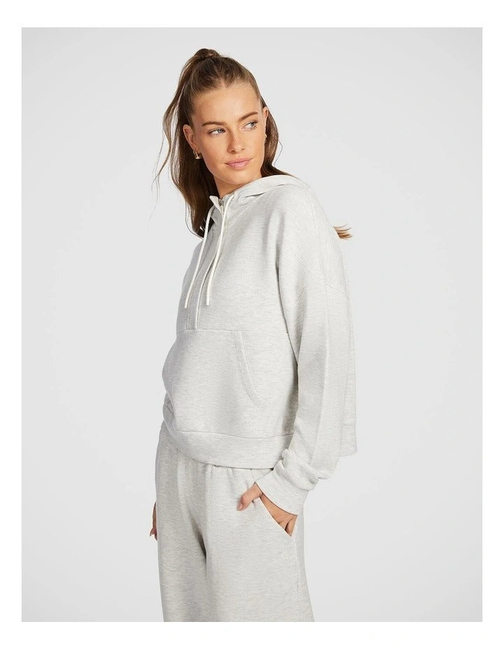 Rockwear Travel Hip Half Zip Hoodie in Grey, featuring a cozy hood and front pockets for a relaxed, stylish fit.