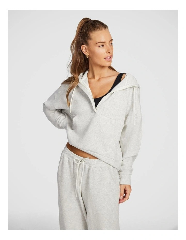 Rockwear Travel Hip Half Zip Hoodie in Grey, featuring a cozy hood and front pockets for a relaxed, stylish fit.
