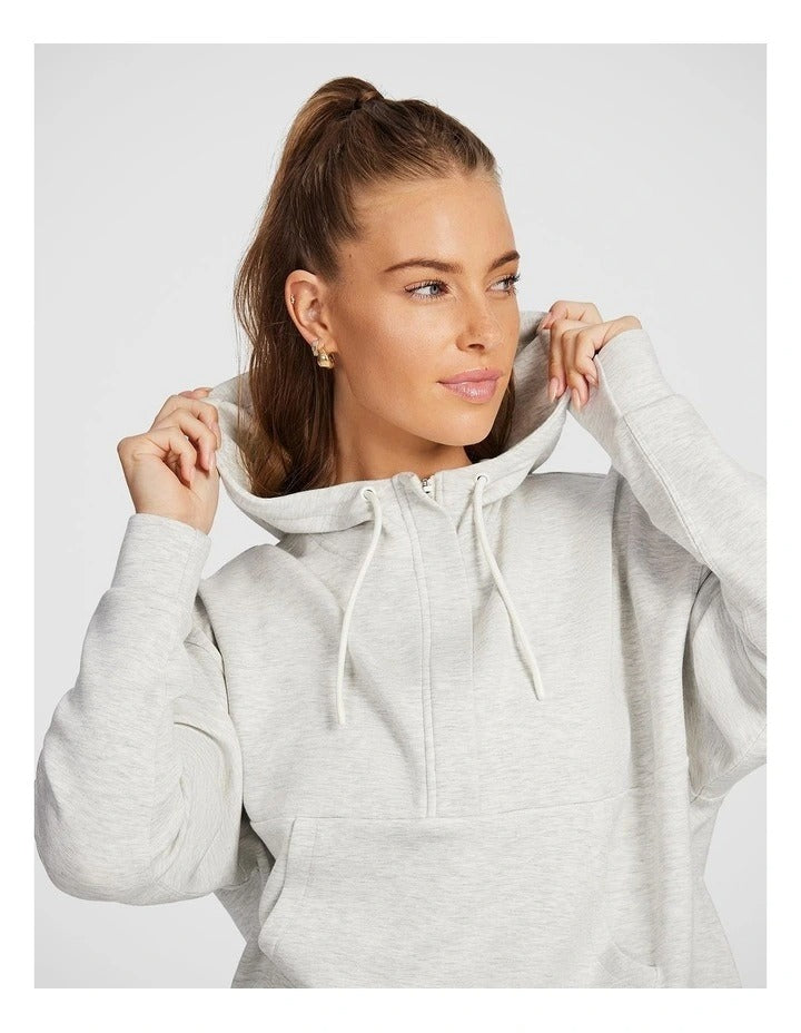 Rockwear Travel Hip Half Zip Hoodie in Grey, featuring a cozy hood and front pockets for a relaxed, stylish fit.