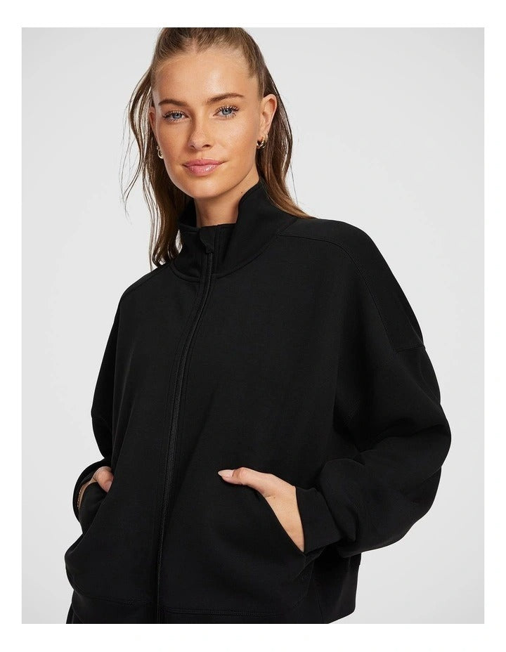 Rockwear Travel Zip Through in Black featuring cozy funnel neck and side pockets for stylish cold-weather wear.