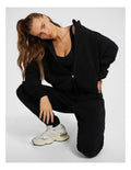 Rockwear Travel Zip Through in Black featuring cozy funnel neck and side pockets for stylish cold-weather wear.