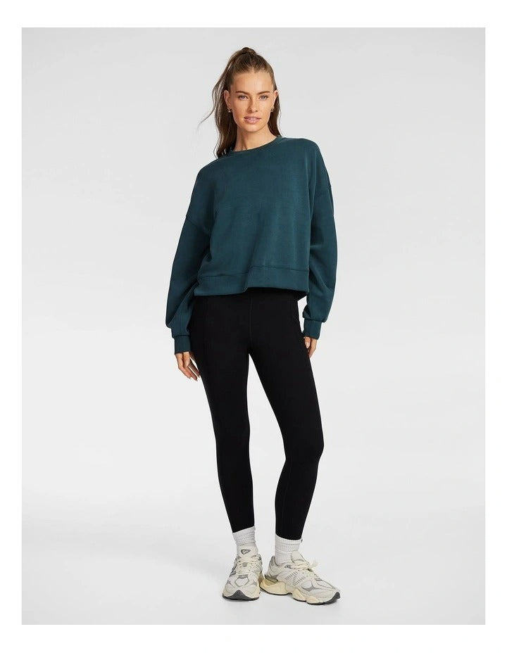 Rockwear Travel Hip Length Crew Sweater in Midnight Green, offering a cozy and relaxed fit for everyday comfort.