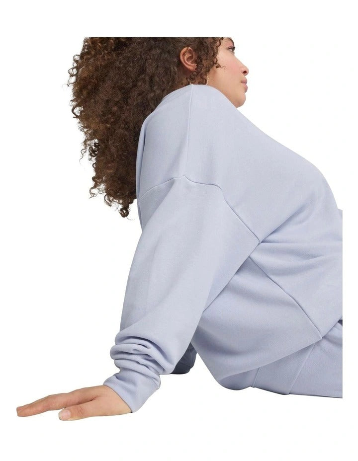 Person wearing a light gray sweatshirt and pants set on a white background