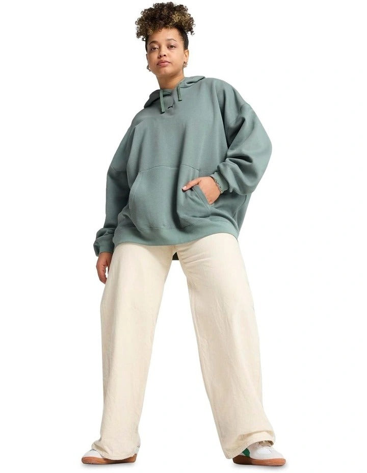 Person wearing a green hoodie on a white background