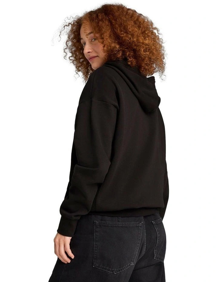 Person wearing a black Puma hoodie with the brand logo on a white background