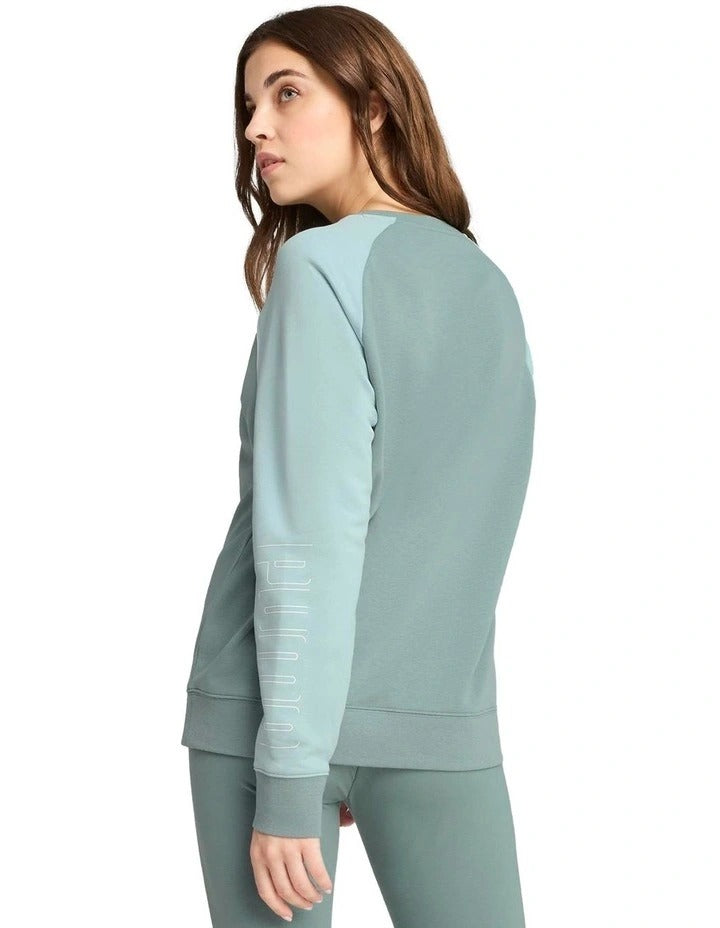 Woman wearing a green tracksuit with a white background