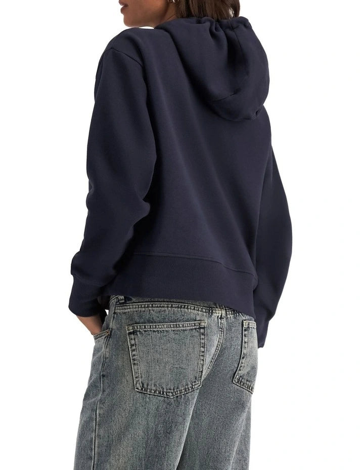 Champion Graphic Hoodie in Deep Navy – Classic pullover hoodie with bold logo print, premium fabric, and relaxed streetwear style.