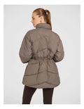 Rockwear Longline Puffer Jacket in Brown, women's full-length puffer jacket with side pockets, padded insulation, and elastic toggle waist for a flattering fit.