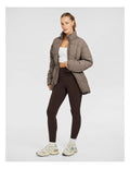 Rockwear Longline Puffer Jacket in Brown, women's full-length puffer jacket with side pockets, padded insulation, and elastic toggle waist for a flattering fit.
