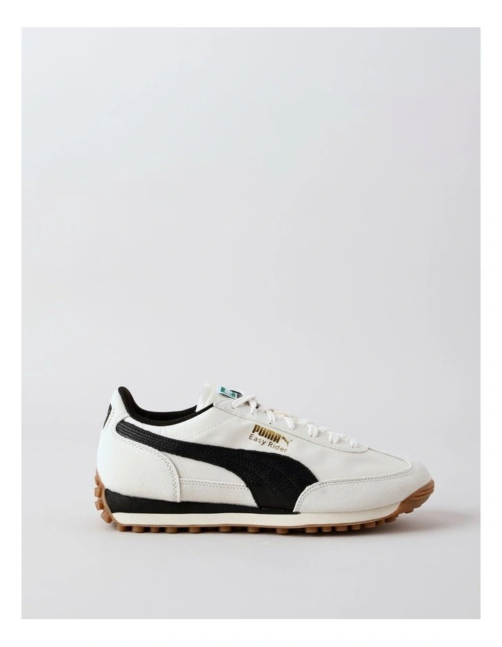 Beige sneaker with brown sole on a white background