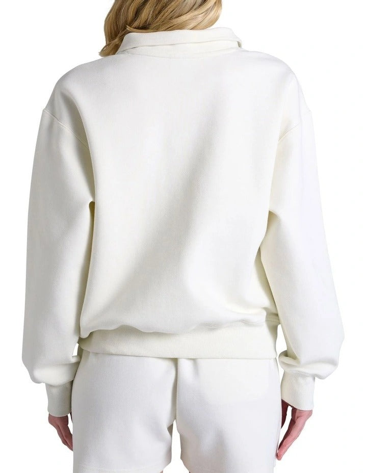 White fleece pullover with a quarter zip and shorts on a white background