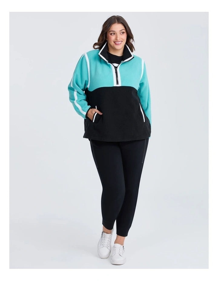 Taking Shape Active Polar Fleece Top Black and Aruba Blue – plus size women’s half zip fleece with high neckline, side pockets, and Heribong tape detail
