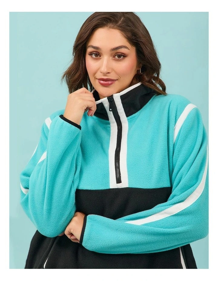 Taking Shape Active Polar Fleece Top Black and Aruba Blue – plus size women’s half zip fleece with high neckline, side pockets, and Heribong tape detail