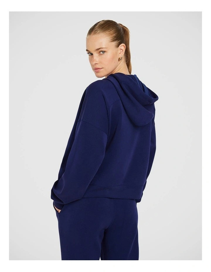 Rockwear Travel Zip Through Hoodie in Blue, featuring a relaxed fit, hip-length silhouette, and side pockets for a cozy, stylish look.