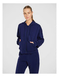 Rockwear Travel Zip Through Hoodie in Blue, featuring a relaxed fit, hip-length silhouette, and side pockets for a cozy, stylish look.
