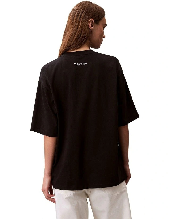 Calvin Klein Jeans oversized black t-shirt with bold logo graphic, boxy silhouette, crew neckline and short sleeves for women