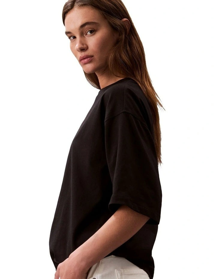 Calvin Klein Jeans oversized black t-shirt with bold logo graphic, boxy silhouette, crew neckline and short sleeves for women