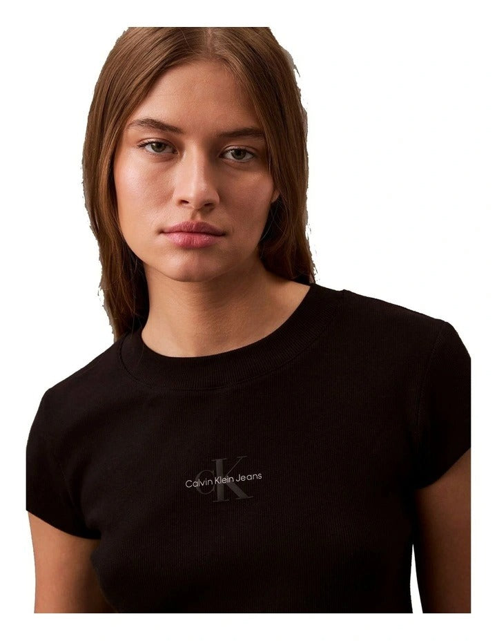 Calvin Klein Jeans black monogram baby tee with slim fit, cropped ribbed fabric, short sleeves, crew neckline and signature logo graphic