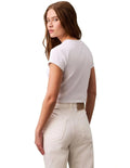 Calvin Klein Jeans white monogram baby tee with slim fit, cropped length, ribbed cotton stretch fabric, short sleeves and crew neck